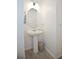 Bathroom showcasing a pedestal sink, modern lighting, and stylish tile flooring at 5009 Skyview Ln, Bradenton, FL 34211