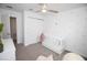 Bright Bedroom with white crib, palm tree decals, and wood ceiling fan at 5009 Skyview Ln, Bradenton, FL 34211
