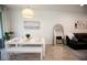 Bright dining area featuring a modern white table set, pendant lighting, and sliding glass door access at 5009 Skyview Ln, Bradenton, FL 34211