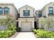 Charming townhouse featuring a one-car garage and well-manicured front yard with flowering bushes at 5009 Skyview Ln, Bradenton, FL 34211