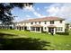 View of the back of a large townhouse with green lawn and enclosed patios perfect for outdoor living at 5009 Skyview Ln, Bradenton, FL 34211