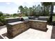 Outdoor kitchen grill with stone surround and stainless steel grill in the Harmony community at 5009 Skyview Ln, Bradenton, FL 34211