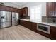 Community kitchen featuring stainless steel appliances, dark wood cabinets, and a tile backsplash at 5009 Skyview Ln, Bradenton, FL 34211