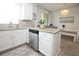 Bright kitchen with stainless steel dishwasher and granite countertop, leading into the dining area at 5009 Skyview Ln, Bradenton, FL 34211