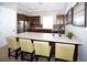 Kitchen featuring an island with bar seating, dark cabinets, and stainless steel appliances at 5009 Skyview Ln, Bradenton, FL 34211