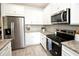 Bright, modern kitchen with stainless steel appliances, granite countertops, and white cabinets at 5009 Skyview Ln, Bradenton, FL 34211