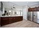 Community kitchen with modern appliances, dark wood cabinets, and a stainless steel refrigerator at 5009 Skyview Ln, Bradenton, FL 34211