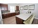 Well-lit kitchen featuring dark wood cabinets and a spacious quartz countertop island with seating at 5009 Skyview Ln, Bradenton, FL 34211