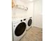 Laundry room featuring a modern washer and dryer set with neutral tile flooring at 5009 Skyview Ln, Bradenton, FL 34211