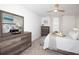 Well-lit bedroom with modern dressers, ceiling fan, and calm, neutral color scheme at 5009 Skyview Ln, Bradenton, FL 34211