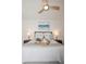 Bright bedroom with a ceiling fan, soft bedding, and decorative bedside lamps at 5009 Skyview Ln, Bradenton, FL 34211