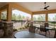 Covered patio with black iron fencing, stone pillars, and ample seating overlooking playground at 5009 Skyview Ln, Bradenton, FL 34211