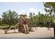 Well-maintained community playground with slides, swings, spring rider, and shaded seating area at 5009 Skyview Ln, Bradenton, FL 34211