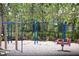 Community playground with swings, airplane spring rider, and lush landscaping behind a secure fence at 5009 Skyview Ln, Bradenton, FL 34211