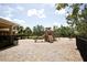 Outdoor playground with slides, swings, and play equipment surrounded by a secure fence and greenery at 5009 Skyview Ln, Bradenton, FL 34211