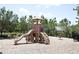 Community playground area featuring various slides, swings, spring rider, and a safe, fenced area at 5009 Skyview Ln, Bradenton, FL 34211