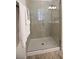 Walk-in shower featuring neutral tile, glass door, and shower head at 5009 Skyview Ln, Bradenton, FL 34211