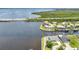 Aerial view of a waterfront property featuring a pool, patio, and private dock with boat lift at 5174 Conner Ter, Port Charlotte, FL 33981