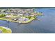 Stunning aerial view showcasing waterfront homes with private docks and lush landscaping on the canal at 5174 Conner Ter, Port Charlotte, FL 33981