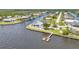 Aerial view of waterfront property with private pool, dock, and boat lift with canal access at 5174 Conner Ter, Port Charlotte, FL 33981