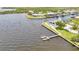 Aerial view of waterfront real estate property featuring pool, boat dock with lift, and canal access at 5174 Conner Ter, Port Charlotte, FL 33981