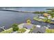 Aerial view of home located waterfront on a canal with a pool, boat lift, and quick Gulf access at 5174 Conner Ter, Port Charlotte, FL 33981