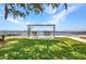 Cozy backyard with mature trees, outdoor swing, and water views, perfect for relaxing at 5174 Conner Ter, Port Charlotte, FL 33981