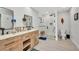 Bright bathroom with a double sink wooden vanity, glass shower and neutral walls and floors at 5174 Conner Ter, Port Charlotte, FL 33981