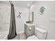 This bathroom features a shower with gray curtain, modern sink, and decor at 5174 Conner Ter, Port Charlotte, FL 33981