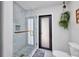 Bathroom featuring a toilet, hanging plants and a glass walk-in shower with herringbone tile floors at 5174 Conner Ter, Port Charlotte, FL 33981