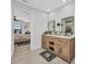 Bright bathroom featuring a double sink wooden vanity and view of a bedroom and the water at 5174 Conner Ter, Port Charlotte, FL 33981