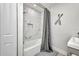This bathroom features a shower with gray curtain, modern sink, and decor at 5174 Conner Ter, Port Charlotte, FL 33981