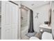 This bathroom features a shower with gray curtain, modern sink, and decor at 5174 Conner Ter, Port Charlotte, FL 33981
