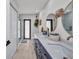 Well-lit bathroom featuring a long blue vanity with double sinks, two round mirrors and a glass shower at 5174 Conner Ter, Port Charlotte, FL 33981