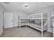 Bedroom featuring two white bunk beds, neutral walls and wood-style floors at 5174 Conner Ter, Port Charlotte, FL 33981