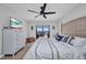Cozy bedroom featuring a ceiling fan, water view, and chest of drawers at 5174 Conner Ter, Port Charlotte, FL 33981