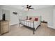The bedroom features wood look tile flooring, ceiling fan, and stylish metal bed frame at 5174 Conner Ter, Port Charlotte, FL 33981
