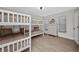 Bright bedroom with two white bunk beds, a dresser, neutral walls and wood-style floors at 5174 Conner Ter, Port Charlotte, FL 33981