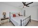 The bedroom features wood look tile flooring, ceiling fan, and stylish metal bed frame at 5174 Conner Ter, Port Charlotte, FL 33981