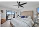 Cozy bedroom features a ceiling fan, water view, and sliding glass doors at 5174 Conner Ter, Port Charlotte, FL 33981