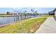 Waterfront property featuring a dock, boat lift and grassy landscaping at 5174 Conner Ter, Port Charlotte, FL 33981