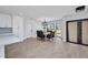 Bright dining area features new floors, modern lighting, and seating for eight at 5174 Conner Ter, Port Charlotte, FL 33981