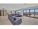 Living area with a modern sofa and large windows showcasing waterfront views at 5174 Conner Ter, Port Charlotte, FL 33981
