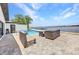Backyard patio featuring refreshing swimming pool and comfortable outdoor furniture with waterfront views at 5174 Conner Ter, Port Charlotte, FL 33981