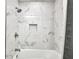 This bathtub features a marble tiled shower and shower niche for storage at 5174 Conner Ter, Port Charlotte, FL 33981