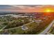 Aerial view of a coastal home near the ocean with lush landscaping at sunset at 530 Spaniards Rd, Placida, FL 33946