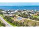 Aerial view showcasing waterfront community and home with a beautiful pool at 530 Spaniards Rd, Placida, FL 33946