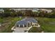 Expansive aerial view of a grand home with a three-car garage, manicured lawn, and lush surroundings at 530 Spaniards Rd, Placida, FL 33946