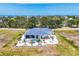 Aerial view of a home showcasing the pool, landscaping, and surrounding neighborhood at 530 Spaniards Rd, Placida, FL 33946