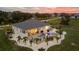 Aerial view of a backyard featuring a pool, patio, and tropical landscaping at 530 Spaniards Rd, Placida, FL 33946